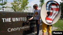 Activists from the Internet Party of Ukraine perform during a rally supporting Edward Snowden, a former contractor at the National Security Agency (NSA), in front of the U.S. Embassy in Kyiv on June 27.
