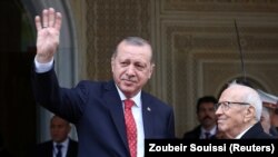Turkey's President Tayyip Erdogan gestures to photographers at Carthage Palace in Tunis, Tunisia, December 27, 2017