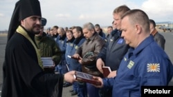 Armenia - A Russian Orthodox priest gives Bibles to Russian Air Force pilots at Erebuni airfield in Yerevan, 14Apr2014.