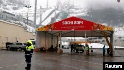 A police officer stands near a checkpoint at the RusSki Gorki Ski Jumping Center in Krasnaya Polyana near Sochi.