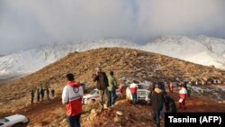 Rescuers search the area of the crash (file photo)