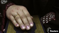 Afghanistan -- A parliamentarian takes an oath on the holy Koran during the opening of the new parliament in Kabul, 26Jan2011