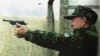 Kazakhstan -- President Nazarbaev fires a pistol at a shooting range