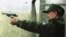 Kazakhstan -- President Nazarbaev fires a pistol at a shooting range