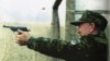 Kazakhstan -- President Nazarbaev fires a pistol at a shooting range