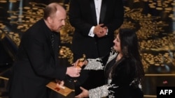 Journalist and filmmaker Sharmeen Obaid Chinoy accepts her award for Best Documentary Short Subject, A Girl in the River from actor and comedian Louis C.K. onstage at the 88th Academy Awards in Hollywood on February 28.