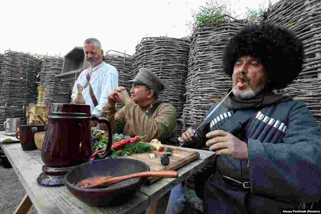 Men enjoy a historically accurate lunch during the battle reenactment. The website of the military-themed park says the aim is to "revive the 2,000-year history of Crimea" and create "a powerful cultural and educational center attracting Crimeans and tourists from all over Russia." 