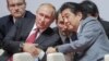 Russian President Vladimir Putin (left) and Japanese Prime Minister Shinzo Abe (right) talk on the sidelines of the Eastern Economic Forum in Vladivostok in September. 