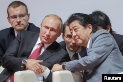 Vladimir Putin with Japanese Prime Minister Shinzo Abe at the Vladivostok Eastern Economic Forum in September last year.