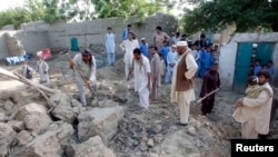 Afghans work on the rubble of a mud house after it collapsed following an earthquake in Jalalabad Province on April 24.