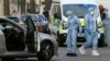 Police forensics officers work at the site where a vehicle rammed the parked car of Ukraine's ambassador outside the Ukrainian Embassy in London on April 13. 