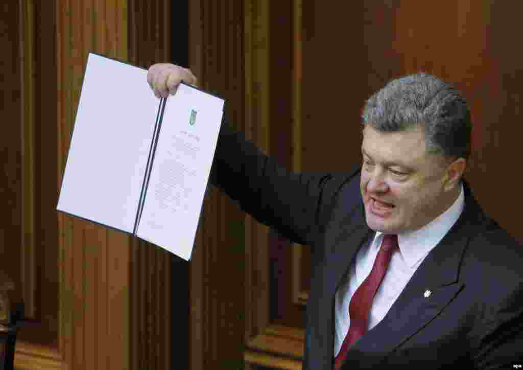 Ukrainian President Petro Poroshenko shows a signed landmark Association Agreement with the European Union during a session of the parliament in Kyiv on September 16. (epa/Sergei Dolzhenko)
