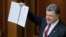 Ukraine -- Ukrainian President Petro Poroshenko shows a signed landmark Association Agreement with the European Union during a session of the parliament in Kyiv, September 16