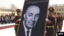 Army officers carry a portrait of late Afghan President Sardar Muhammad Daud during his funeral in Kabul in March 2009.