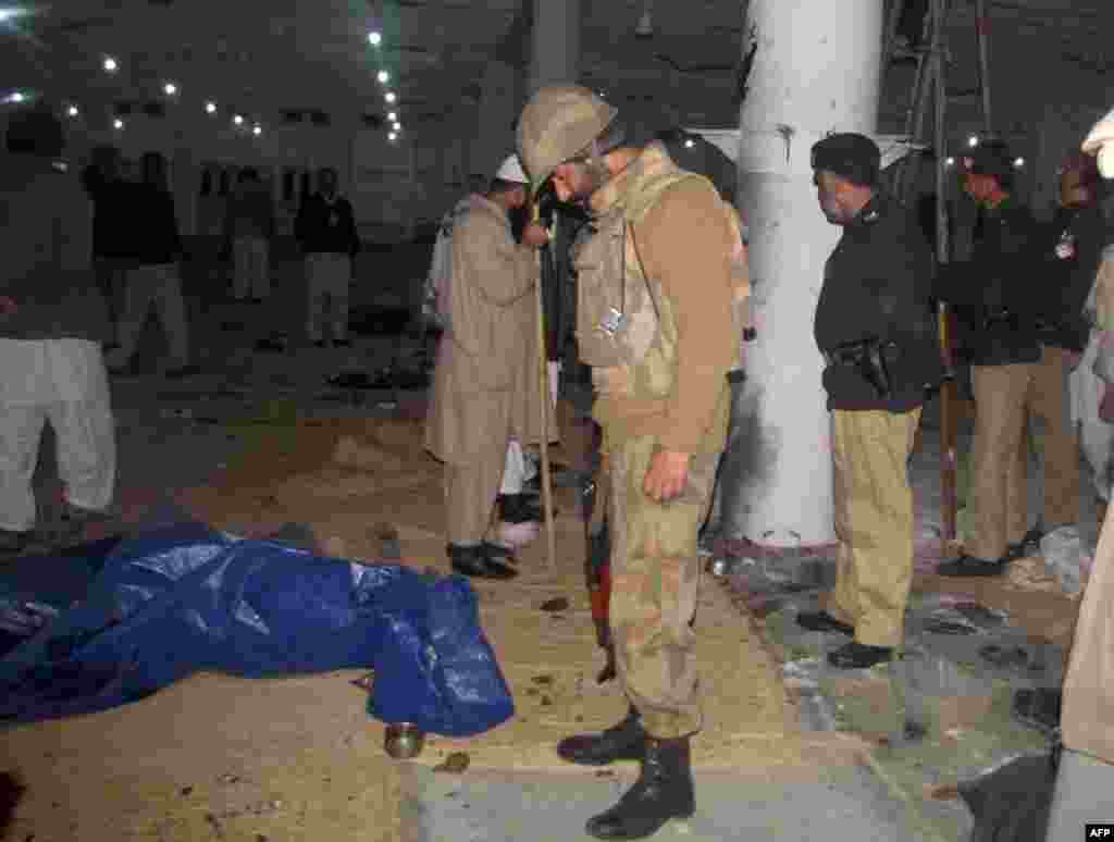 Police inspect the damage to a mosque bombing.