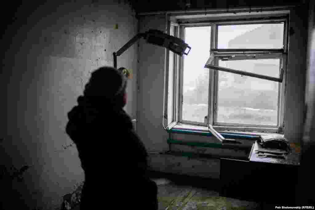 Marchenko stands inside a health clinic damaged by fighting.&nbsp;