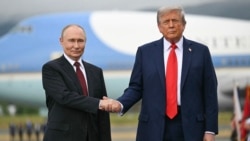 US President Donald Trump greets Russian President Vladimir Putin on the tarmac after they arrived in Anchorage, Alaska, on August 15.