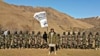 The Taliban assigned Tajik militant Muhammad Sharifov (center), who goes by the alias Mahdi Arsalon, to raise the Taliban flag at a strategic checkpoint near Afghanistan's border with Tajikistan last month.