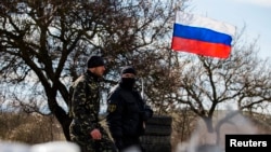 Members of a "local self-defense unit" man a checkpoint on the highway between Simferopol and Sevastopol in Crimea in March 2014.