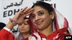 Deaf-mute Indian woman Geeta salutes the media before leaving for the airport from the EDHI Foundation in Karachi on October 26, 2015