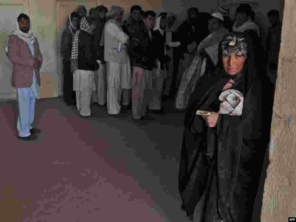 A near-record 3.2 million people returned to their homes in 2011, the UN says. This Afghan woman, seen at a registration center in Herat, was repatriated from Iran.