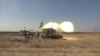 Iraqi Army self-propelled 155mm Paladin howitzer artillery fires from the east of Mosul at IS militants.