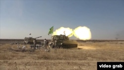 Iraqi Army self-propelled 155mm Paladin howitzer artillery fires from the east of Mosul at IS militants.