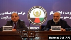 Afghan intelligence chief Masoom Stanekzai (right) and Interior Minister Wais Barmak hold a news conference in Kabul on February 1.