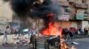 Anti-government protesters set fire and block roads in Baghdad, Iraq, Wednesday, Oct. 2, 2019. 