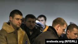 Russians Іvan Gaponov (left) and Artyom Breus (second from right) were each fined $3,000 for their participation in postelection activities in Belarus. 