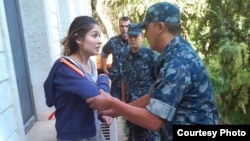 One of the last photographs of Gulnara Karimova, purportedly showing her being put under house arrest in 2014.