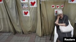 A Tymoshenko supporter sits in a protest tent camp in central Kyiv in mid-June.