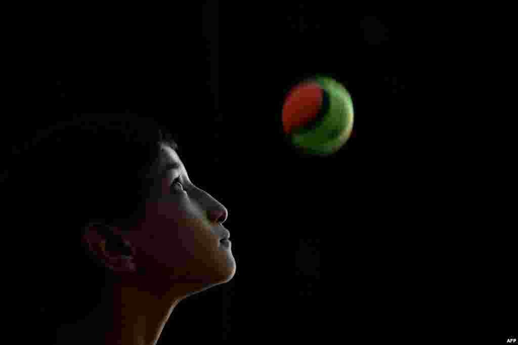 Shah Hussain, 12, performs during the 8th Afghanistan Juggling Championships.