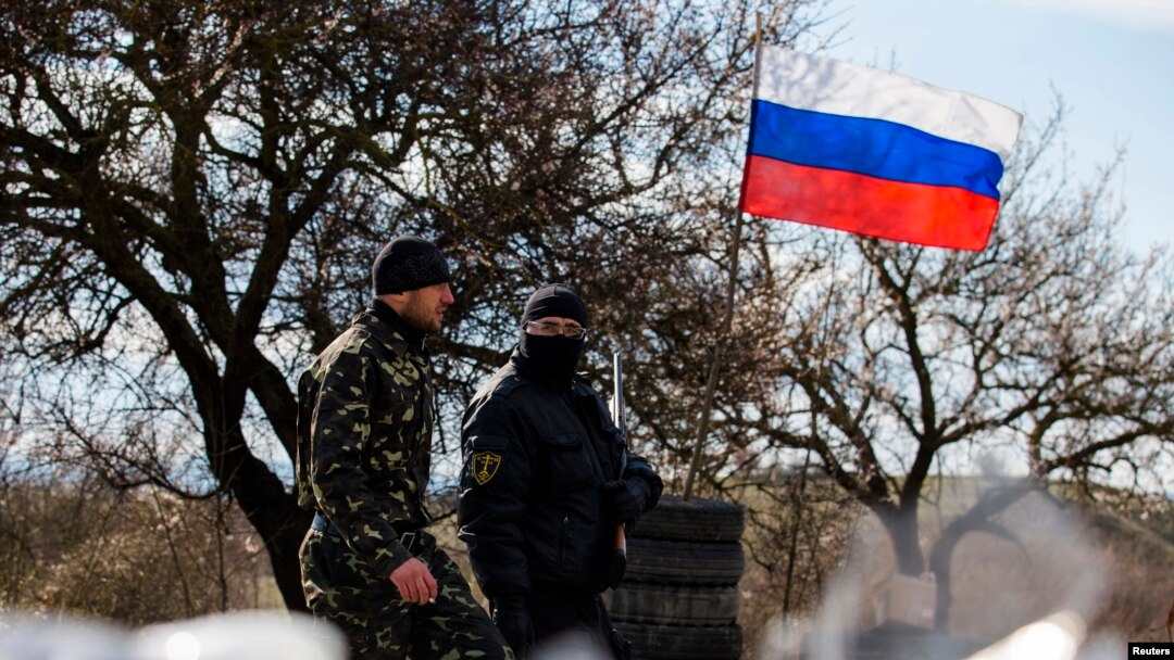 Members of a "local self-defense unit" man a checkpoint on the highway between Simferopol and Sevastopol in Crimea in March 2014.