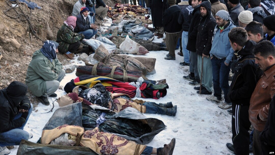 Locals gather in front of the bodies of people who were killed in an air strike in southeastern Turkey on December 29.