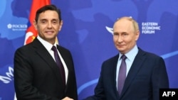 Serbian Deputy Prime Minister Aleksandar Vulin (left), whose party sponsored the bill, meets with Russian President Vladimir Putin on the sidelines of the Eastern Economic Forum in Vladivostok in September.