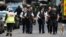 Armed police officers walk outside London's Borough Market where a terror attack on June 3 left seven people dead. 