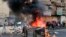 Anti-government protesters set fire and block roads in Baghdad, Iraq, Wednesday, Oct. 2, 2019. 