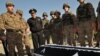 Armenia -- Servicemen stand near the coffin of Manvel Saribekyan, an Armenian taken captive by Azerbaijani forces, during his body's return to Azerbaijan on the Ijevan-Qazax highway near the village of Kayan, 04Nov2010