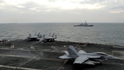 File photo shows jets aboard an aircraft carrier in the Strait of Hormuz. US Central Command said it hit several Iranian sites on June 26 in response to earlier attacks against commercial shipping.