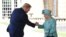 Queen Elizabeth II greets U.S. President Donald Trump as he arrives for the ceremonial welcome at Buckingham Palace on June 3.