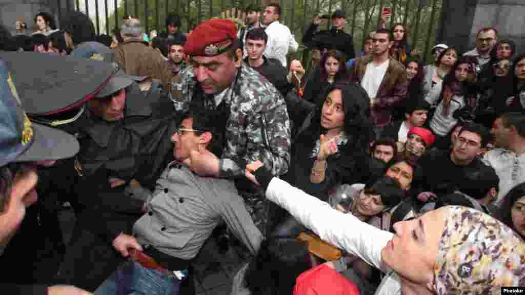 Riot police detain young opposition activists in Yerevan.