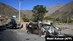 A burnt-out Humvee sits on a roadside in the Dashtak district of Panjshir Province in September 2021