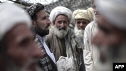 Tribal elders speak with a district governor at a shura in Helmand Province. Contact with government officials can be a death sentence for what were the unchallenged authorities in tribal politics.