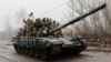 Ukrainian soldiers ride atop a tank in the Chernihiv region on April 2.