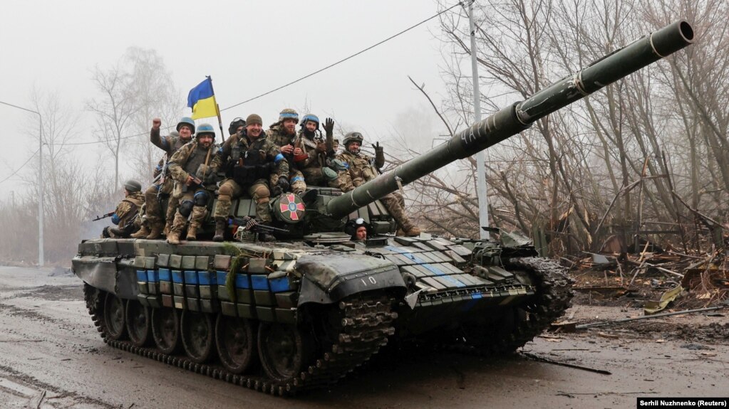 Ukrainian soldiers ride atop a tank in the Chernihiv region on April 2.