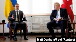 British Prime Minister Boris Johnson (left) and Ukrainian President Volodymyr Zelensky meet for talks during the Munich Security Conference in Munich on February 19.