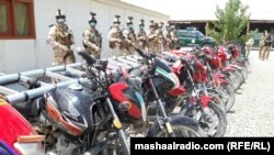 Afghan army soldiers stand behind the Taliban motorcycles they have captured in the southeastern province of Paktia.