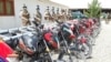 Afghan army soldiers stand behind the Taliban motorcycles they have captured in the southeastern province of Paktia.