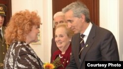 Prague -- RFE/RL President Gedmin receives his award from Defense Minister Parkanova while Ms. Albright looks on.